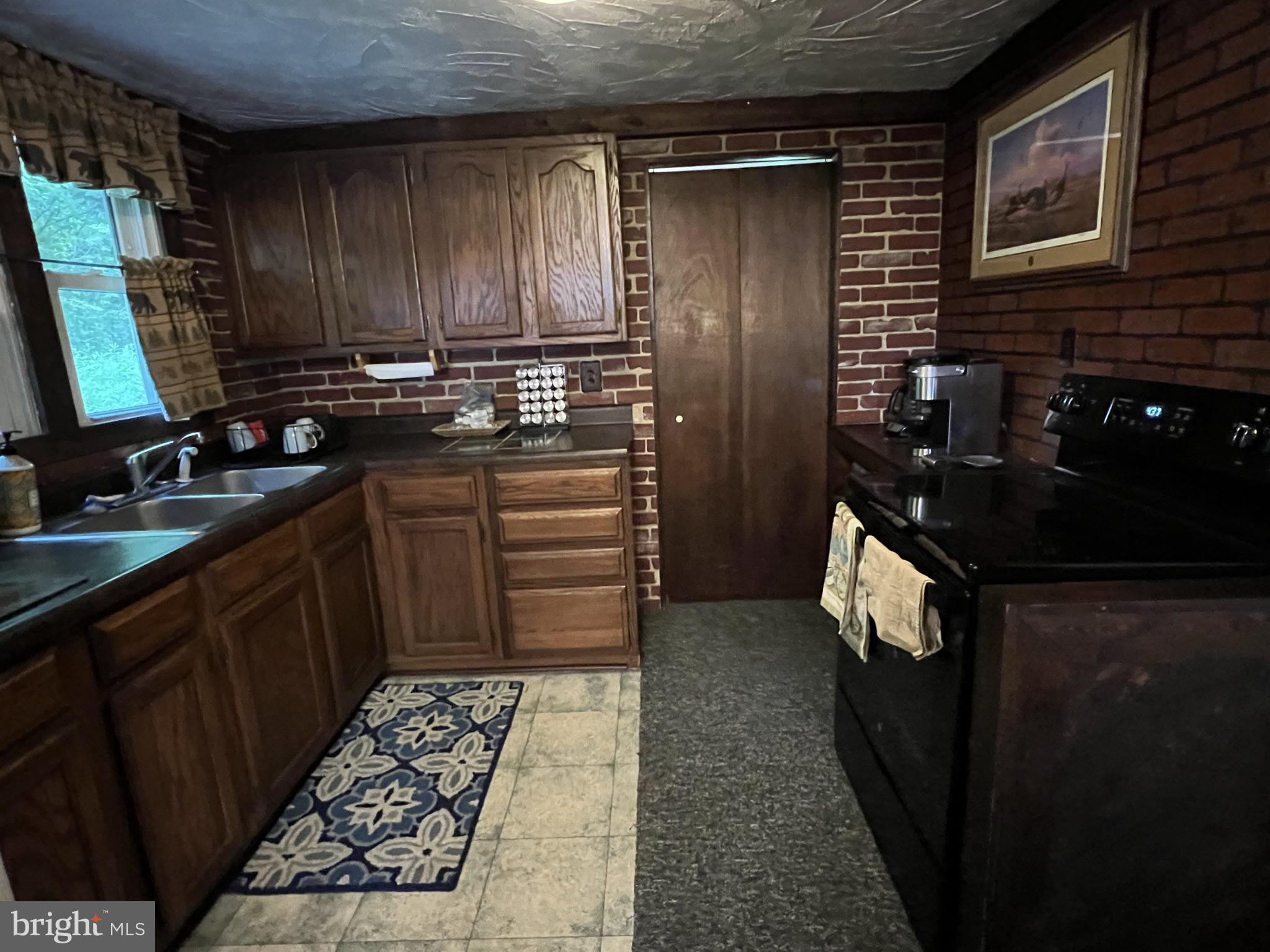 193 Gravelly Run Road McHenry, MD 21541 - Photo 25 of 57 a kitchen with a sink stove and refrigerator