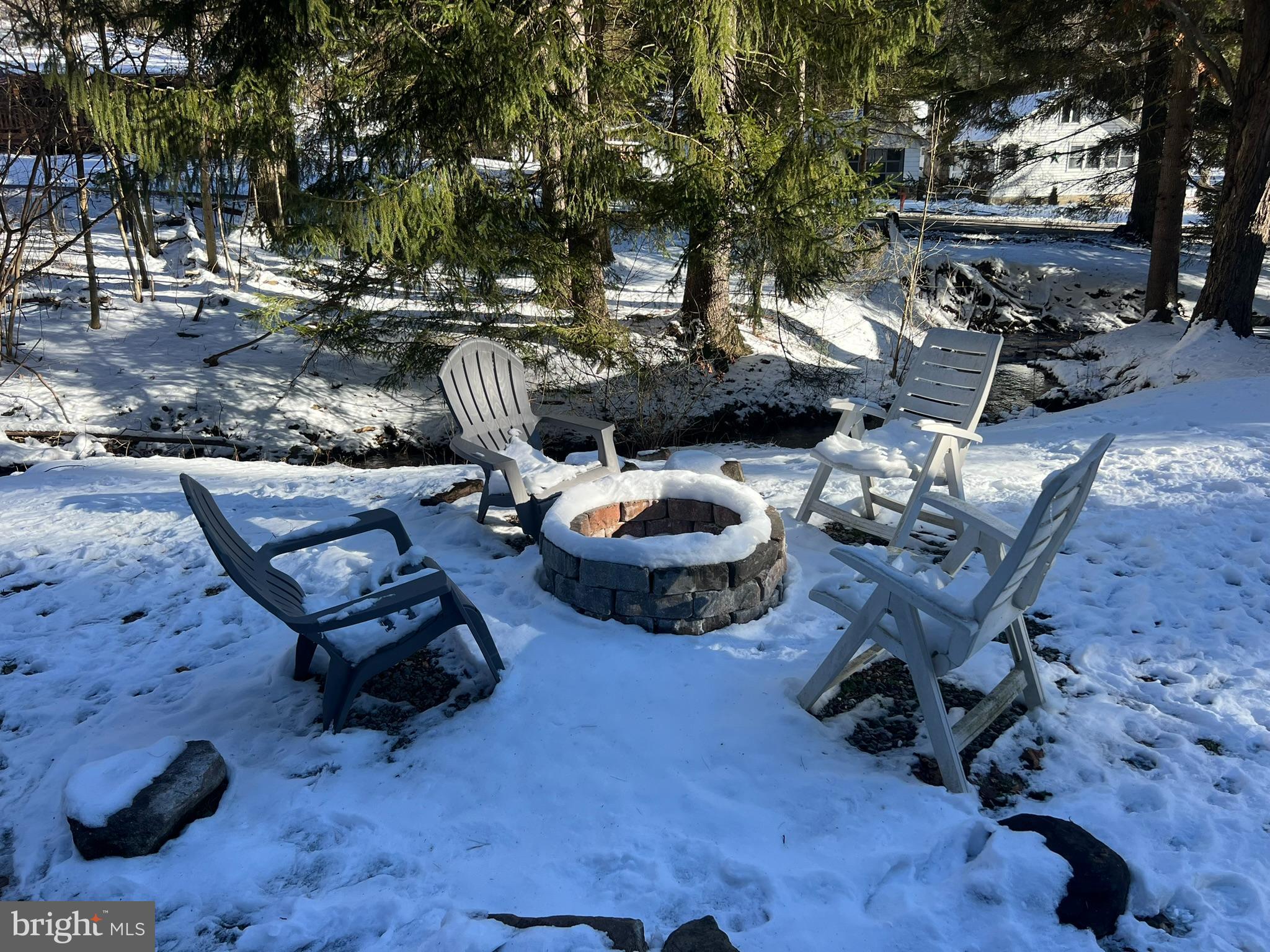 193 Gravelly Run Road McHenry, MD 21541 - Photo 56 of 57 a view of a backyard with table and chairs potted plants and large tree