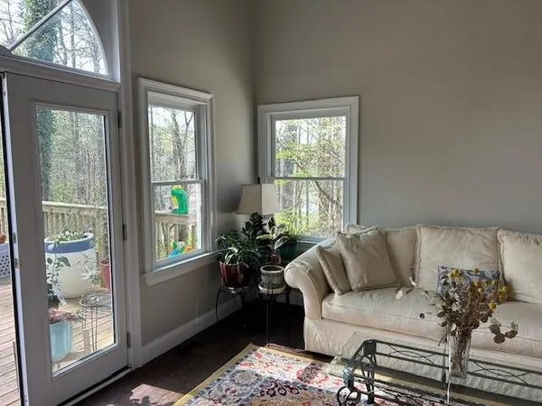 a living room with furniture and next to a window
