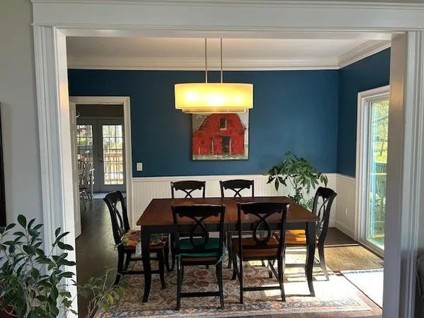 a dining room with furniture and window