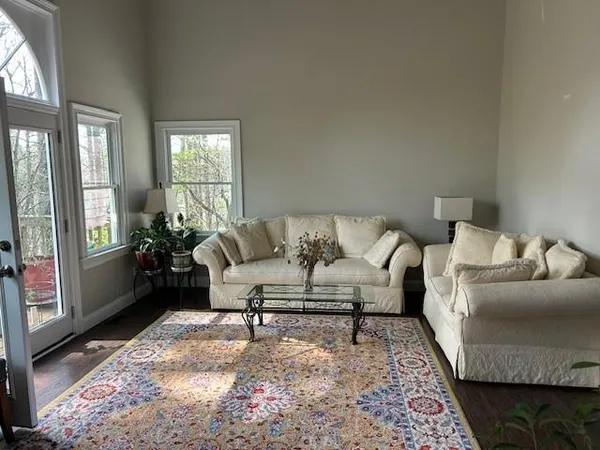 a living room with furniture and a rug