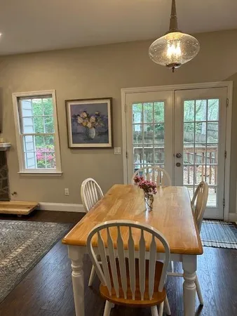 a view of a dining room with furniture wooden floor and chandelier