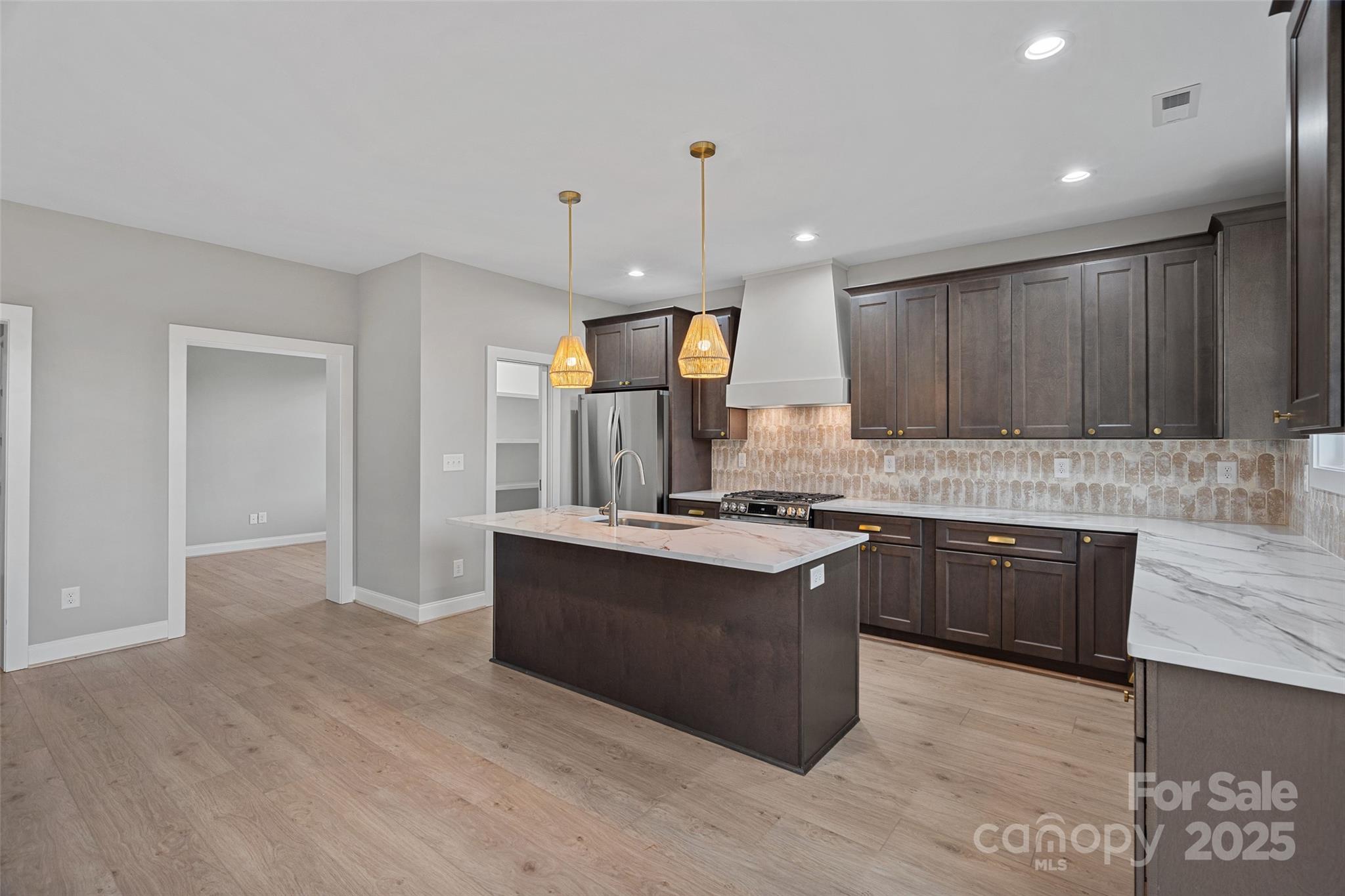 155 Rimrock Road Harmony, NC 28634 - Photo 15 of 39 a kitchen with granite countertop a stove top oven a sink dishwasher and a refrigerator with wooden floor