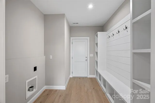 a view of bathroom with bathtub wooden floor and window