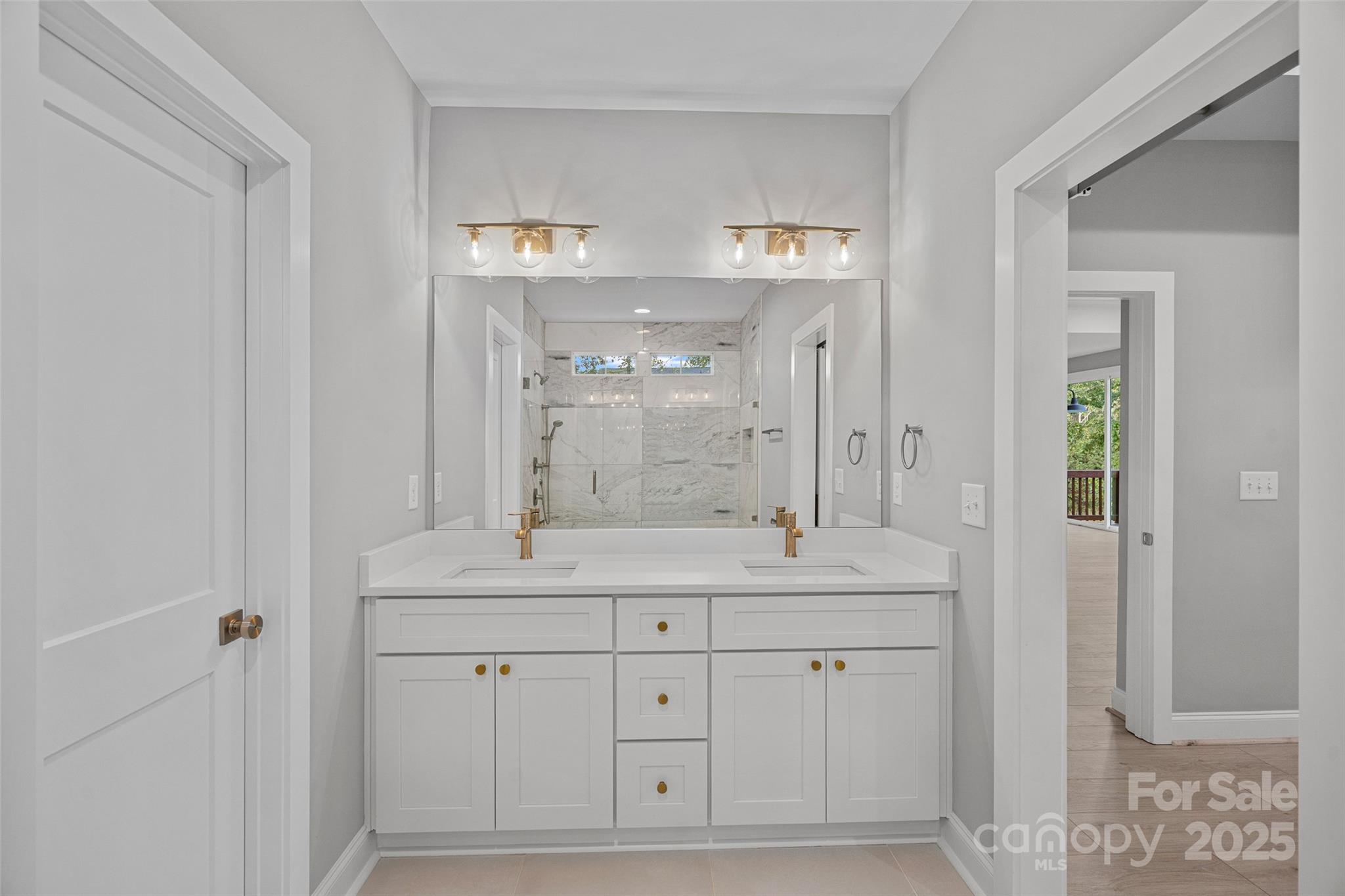155 Rimrock Road Harmony, NC 28634 - Photo 24 of 39 a bathroom with double sink and a mirror