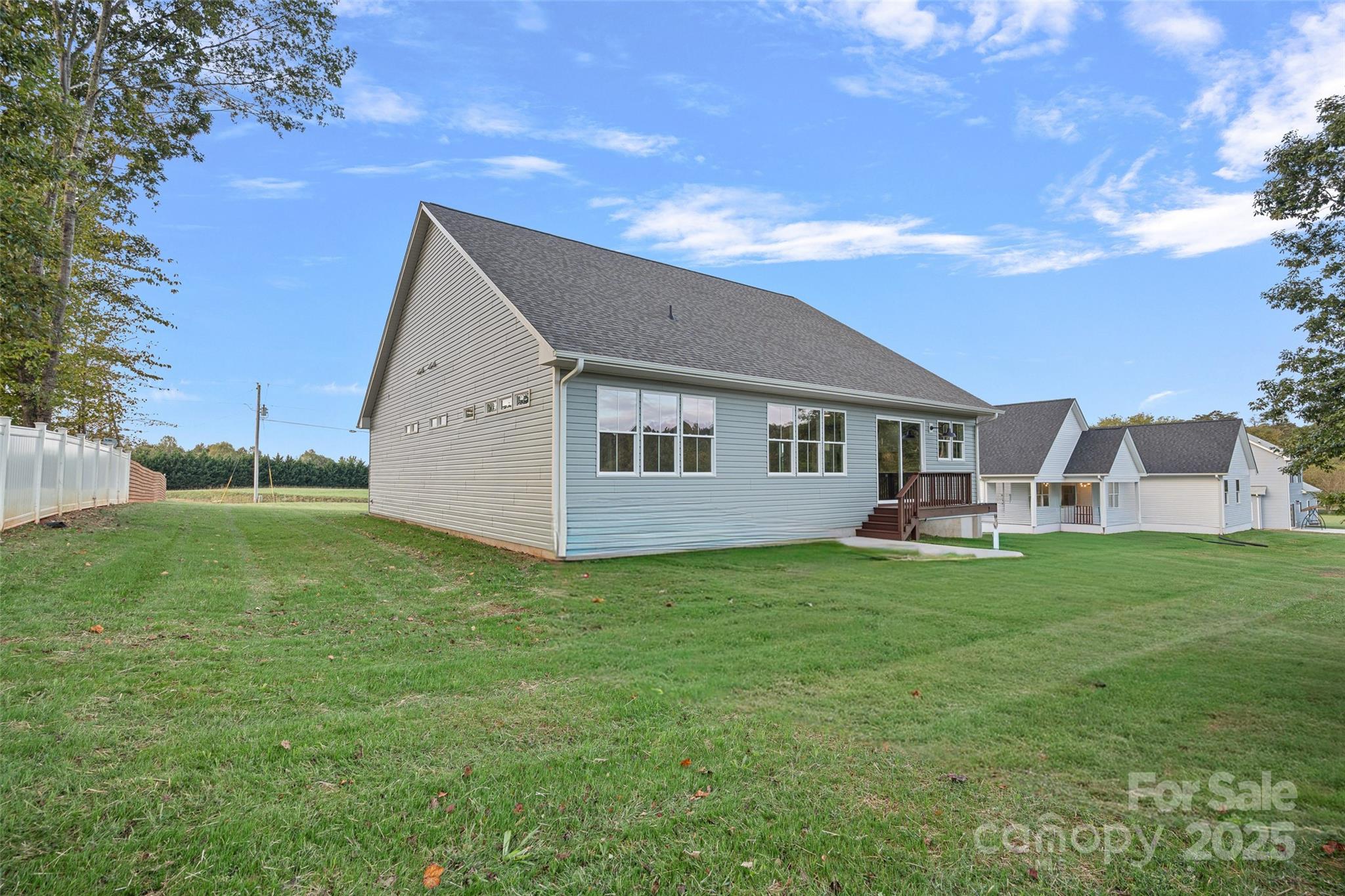155 Rimrock Road Harmony, NC 28634 - Photo 32 of 39 a backyard of a house with table and chairs