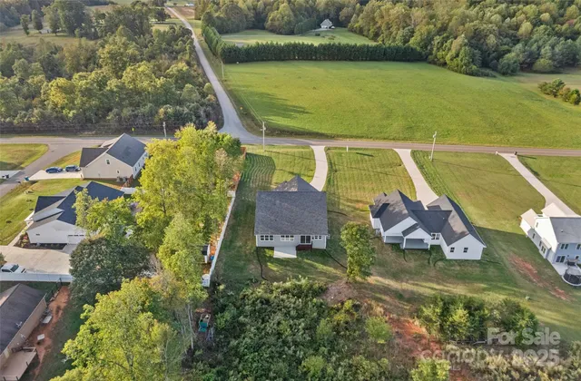 an aerial view of a house with a yard basket ball court and outdoor seating