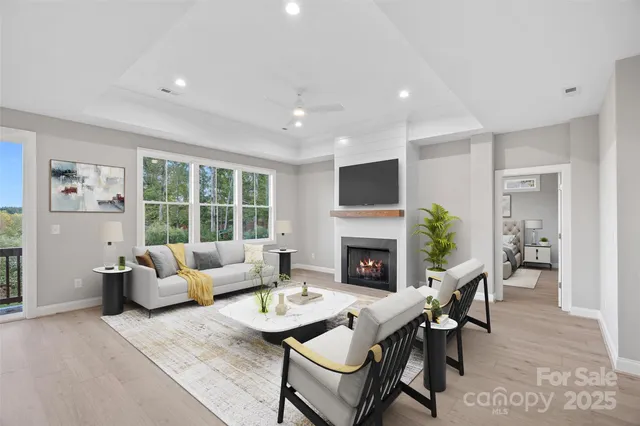 a living room with furniture a fireplace and a flat screen tv