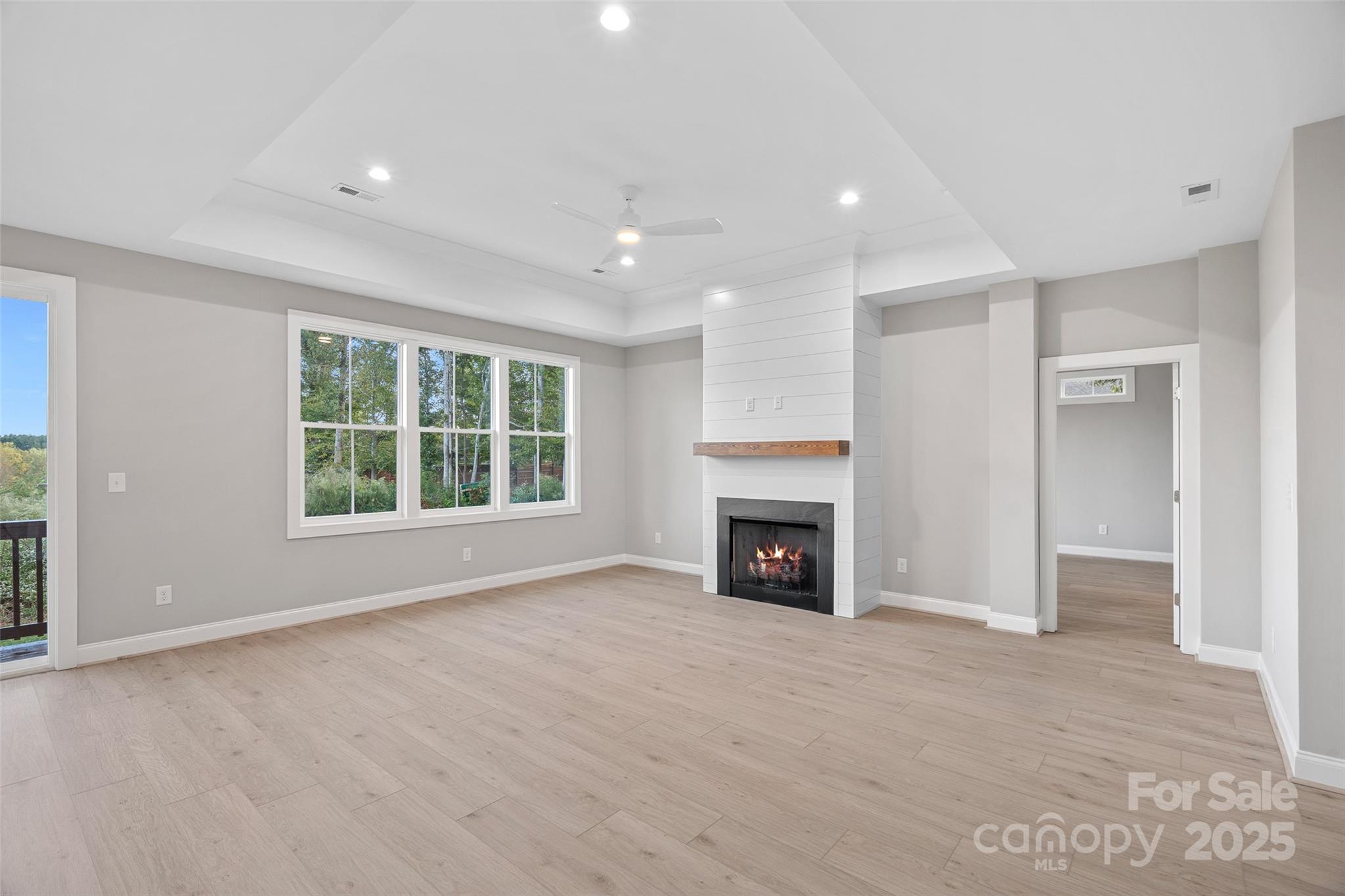 155 Rimrock Road Harmony, NC 28634 - Photo 9 of 39 a view of an empty room with a fireplace and a window