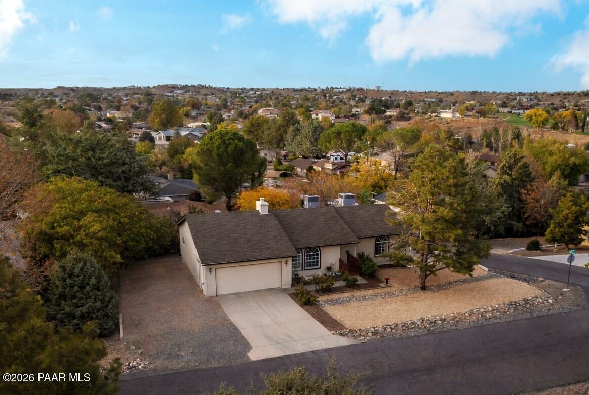 an aerial view of a house with a yard