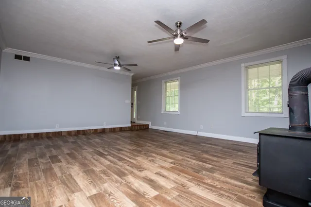 wooden floor in an empty room with a window