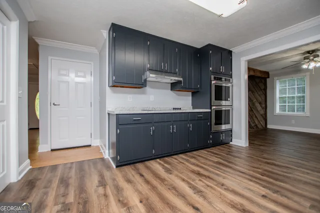 a kitchen with wooden cabinets and a sink