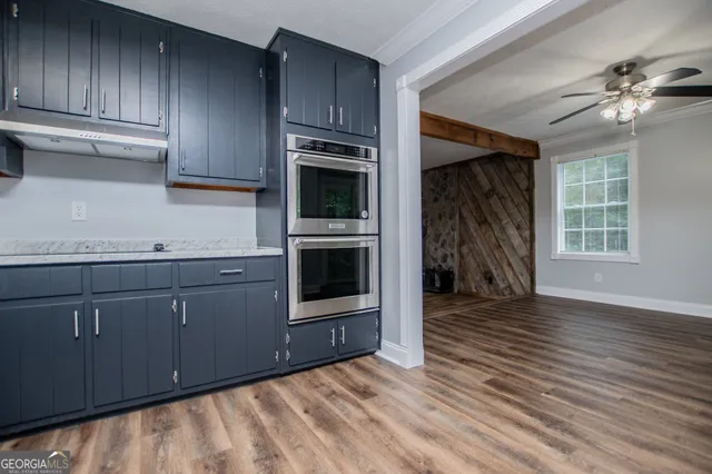 a view of an empty room with wooden floor