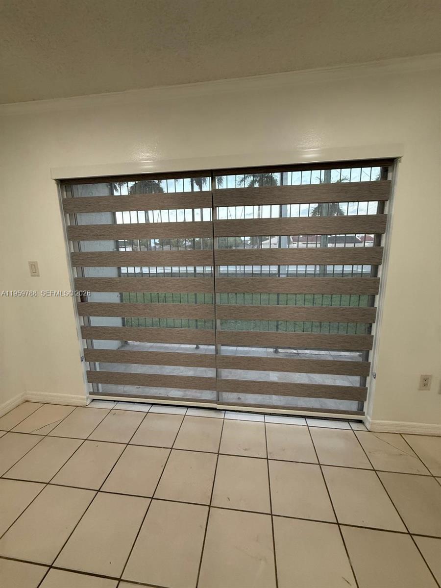 9520 Southwest 8th Street, Unit 111 Miami, FL 33174 - Photo 12 of 31 a view of empty room with wooden floor and fan