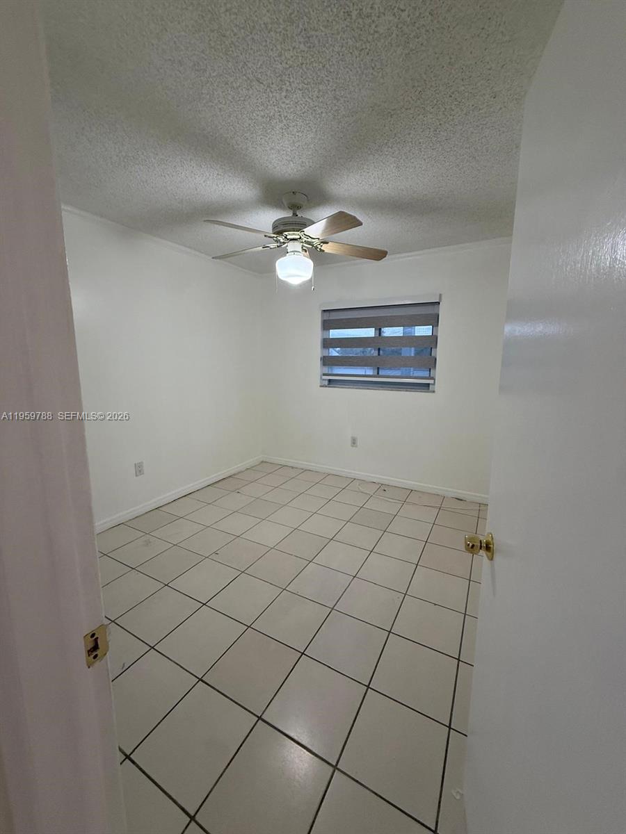 9520 Southwest 8th Street, Unit 111 Miami, FL 33174 - Photo 18 of 31 a view of an empty room and a ceiling fan