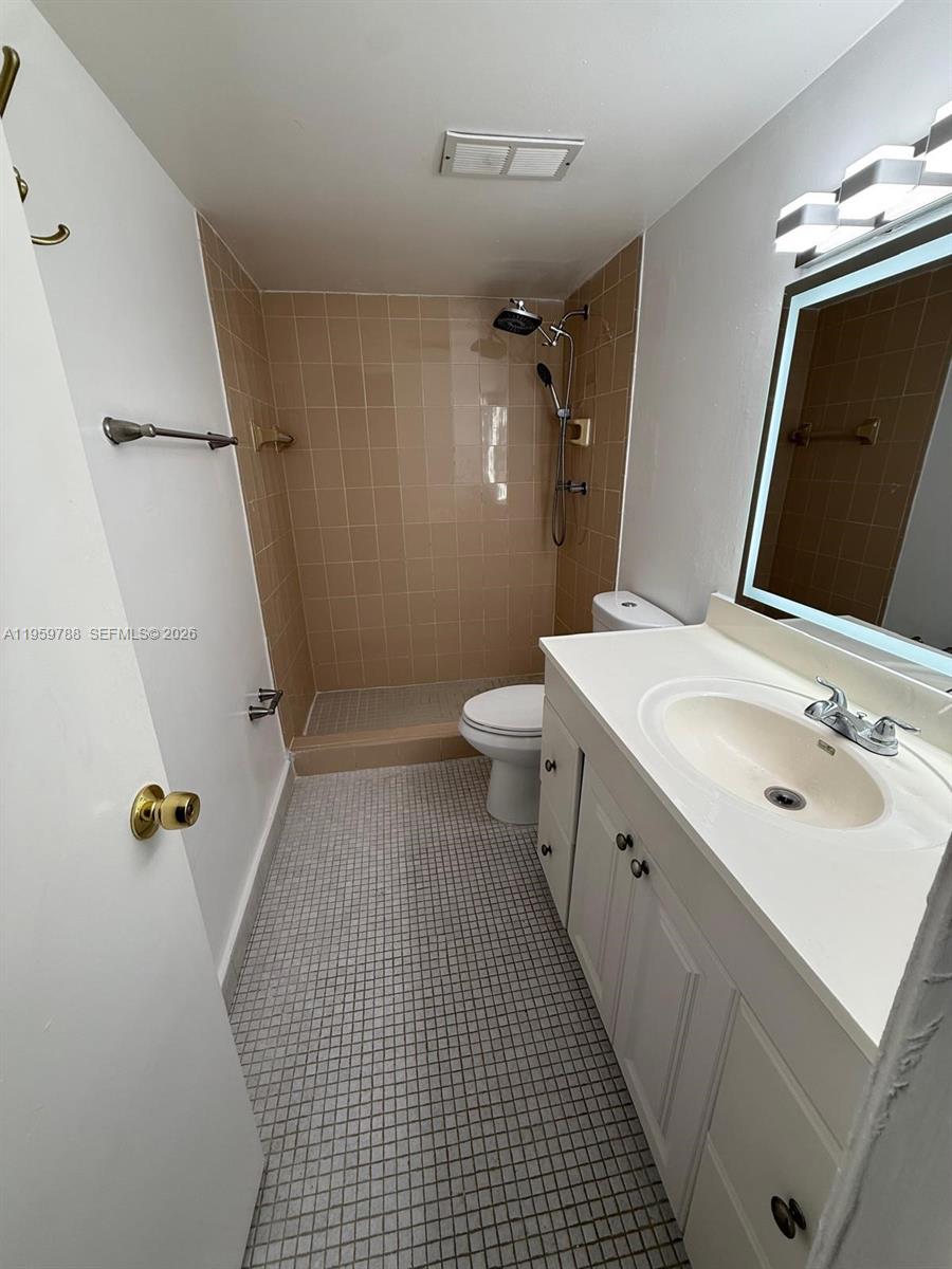 9520 Southwest 8th Street, Unit 111 Miami, FL 33174 - Photo 21 of 31 a bathroom with a sink a toilet and shower