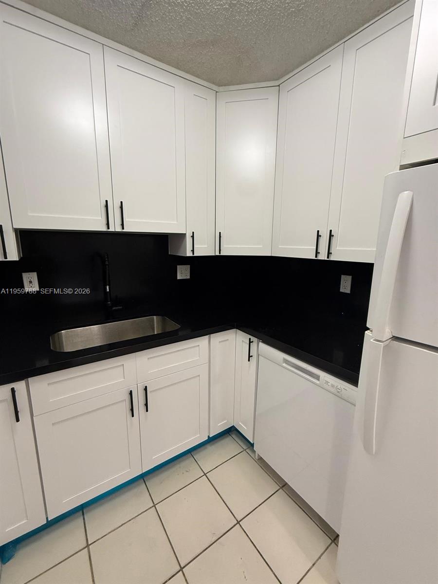 9520 Southwest 8th Street, Unit 111 Miami, FL 33174 - Photo 5 of 31 a view of a refrigerator a sink and dishwasher