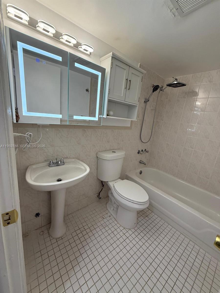 9520 Southwest 8th Street, Unit 111 Miami, FL 33174 - Photo 6 of 31 a bathroom with a toilet a sink and bathtub