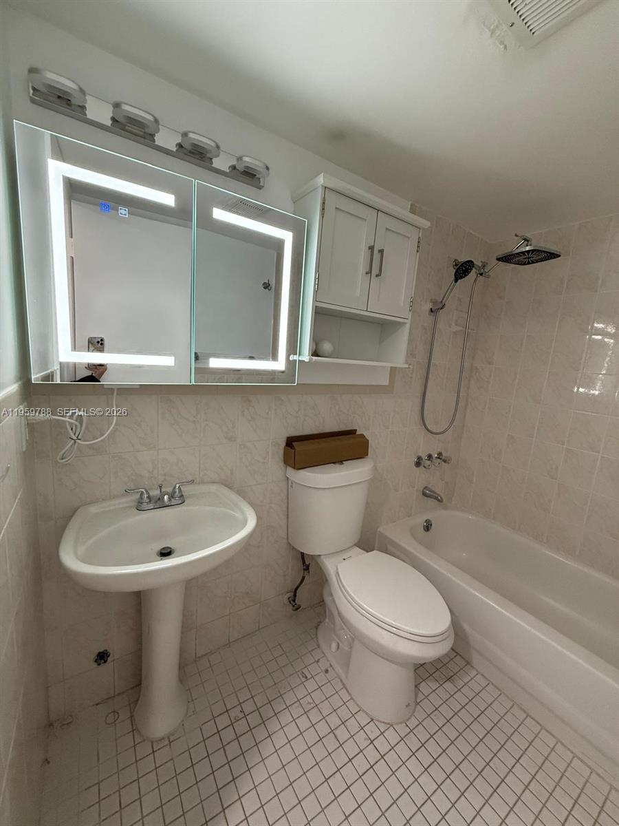 9520 Southwest 8th Street, Unit 111 Miami, FL 33174 - Photo 7 of 31 a bathroom with a toilet sink and shower