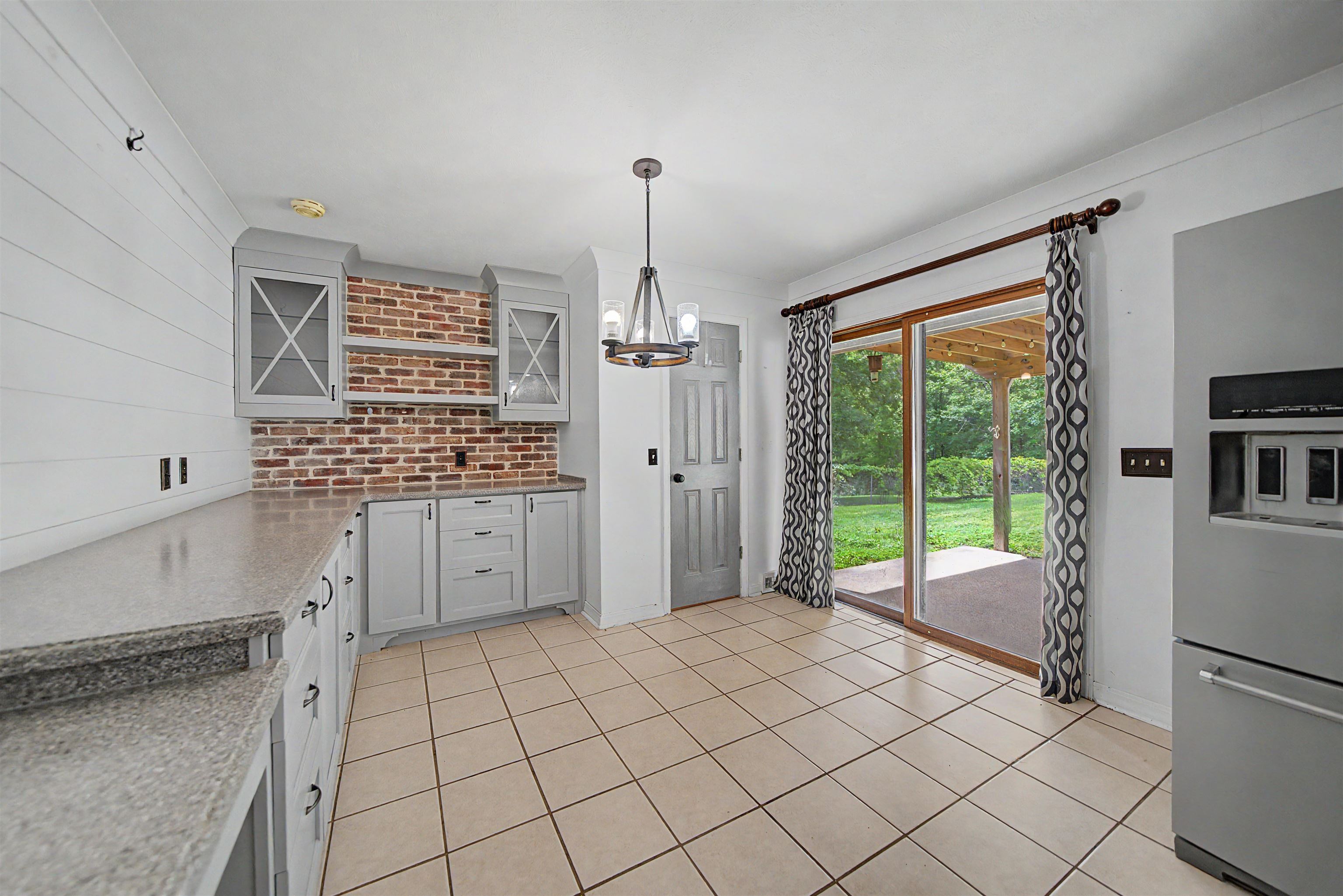 436 Skyline Road Selmer, TN 38375 - Photo 34 of 40 Kitchen area featuring light gray cabinetry, a brick backsplash, and light-toned countertops