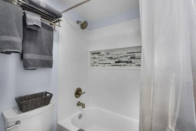 a bathroom with a bathtub and shower