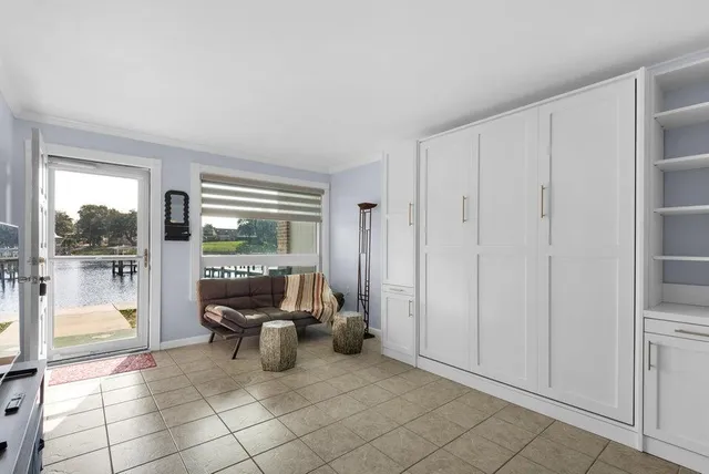 a living room with furniture and a floor to ceiling window
