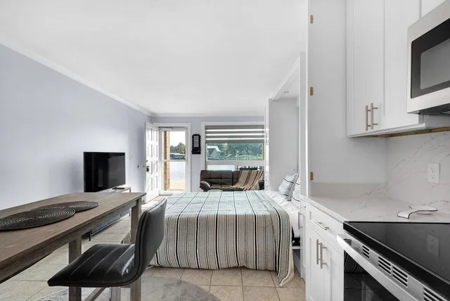 a bedroom with a bed and a tv