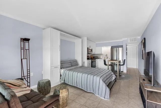 a bedroom with a bed and a flat screen tv