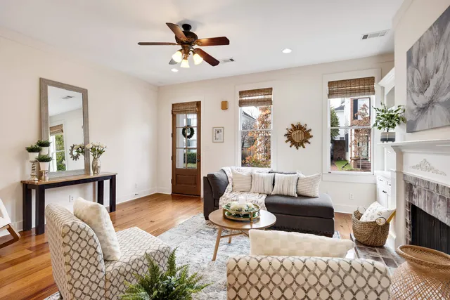 a living room with furniture a fireplace and a table