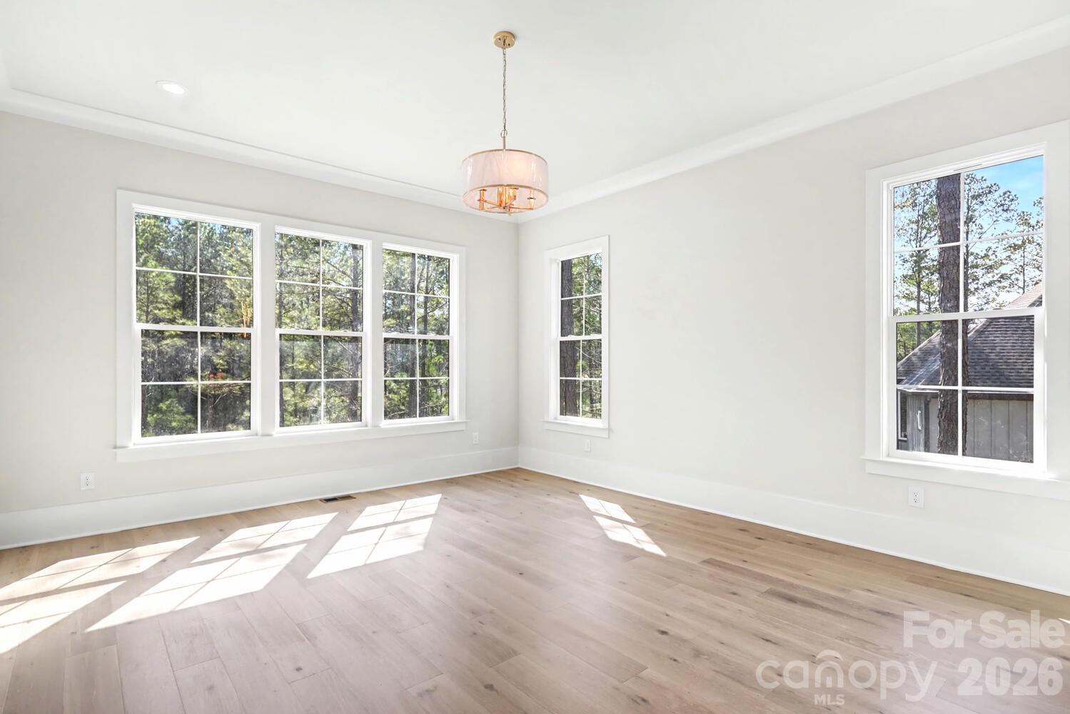 3210 Sherman Drive Lancaster, SC 29720 - Photo 31 of 45 a view of an empty room with wooden floor and a window