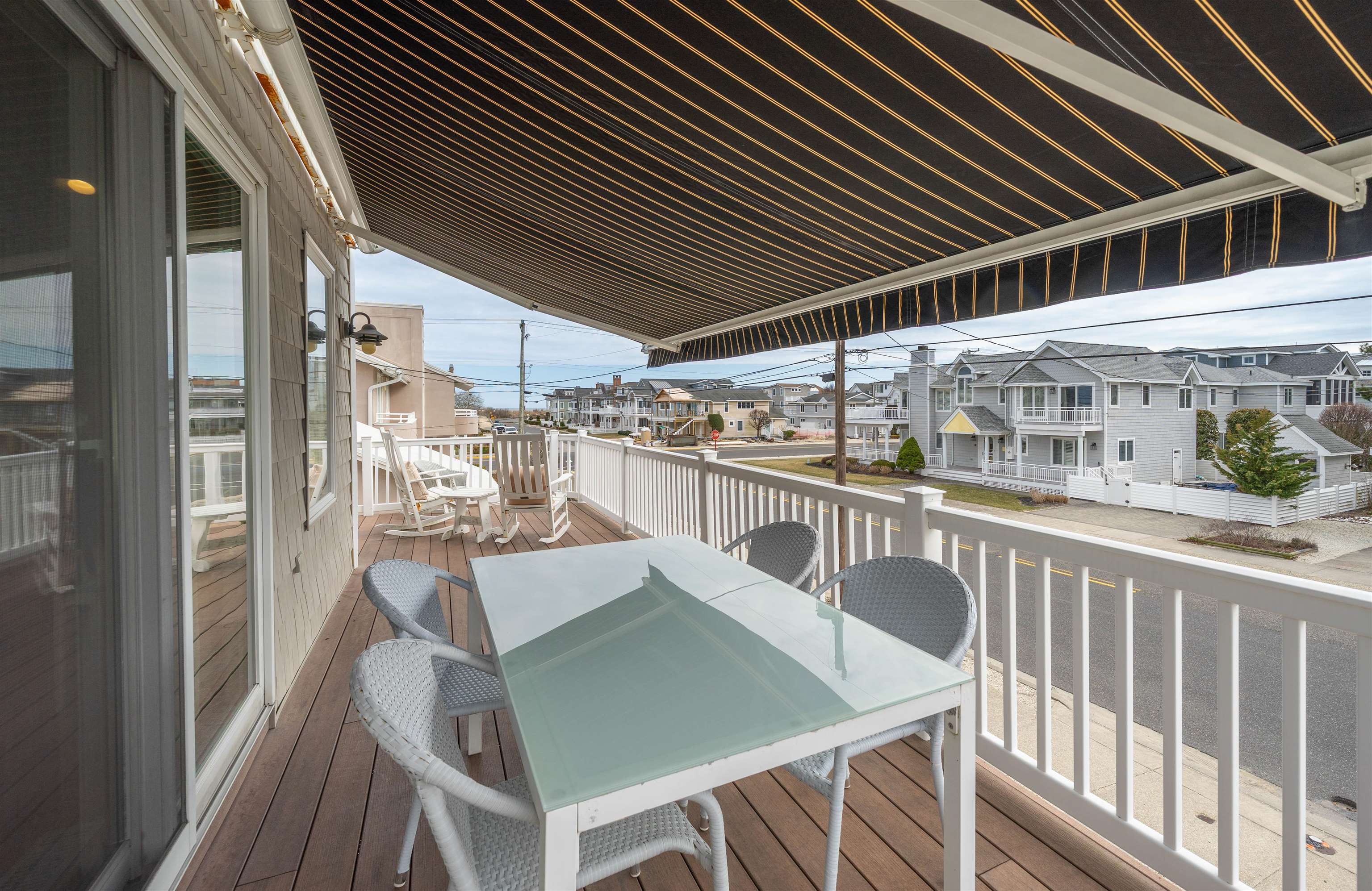 25 9th Street Avalon, NJ 08202 - Photo 11 of 32 a view of a patio with table and chairs with wooden floor and fence
