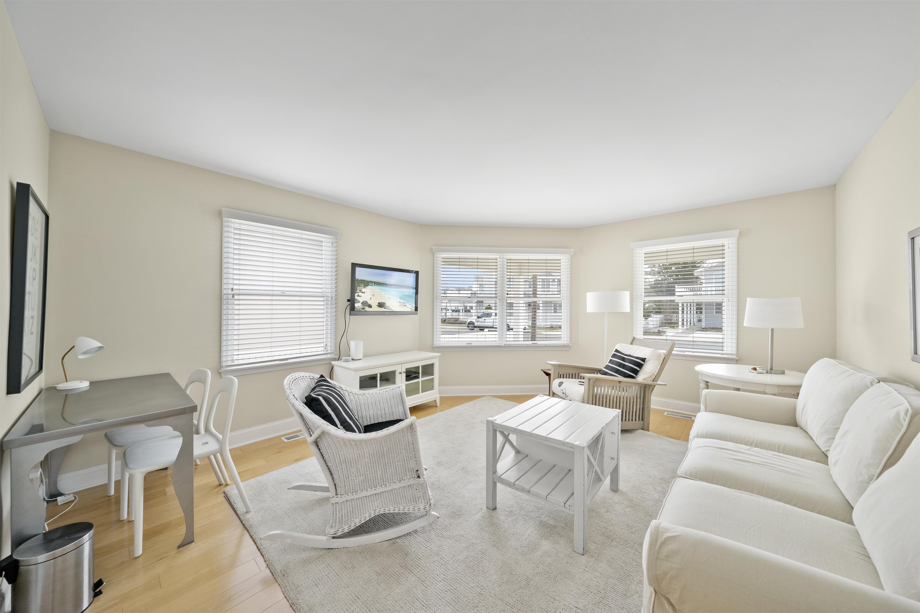25 9th Street Avalon, NJ 08202 - Photo 17 of 32 a living room with furniture a table and a large window