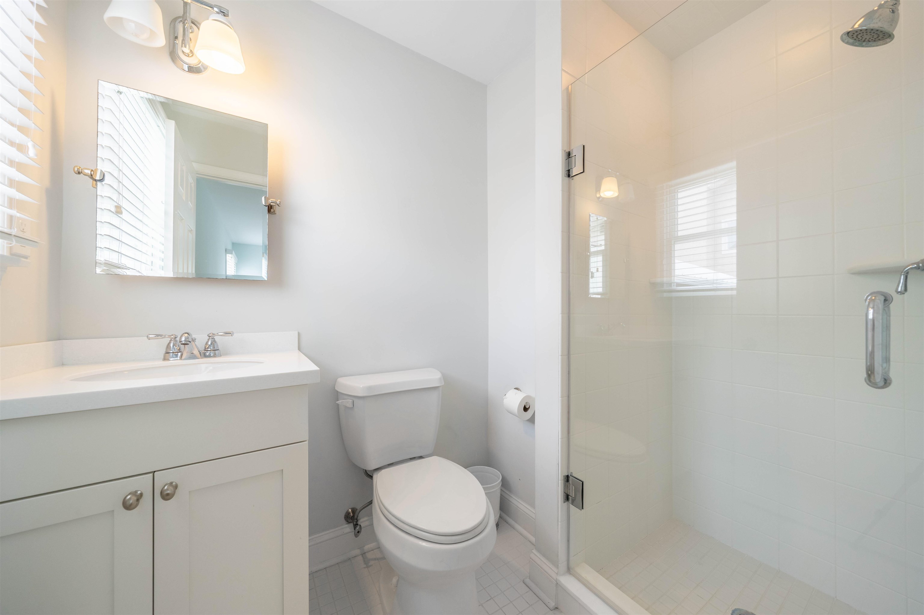 25 9th Street Avalon, NJ 08202 - Photo 18 of 32 a bathroom with a sink toilet and vanity