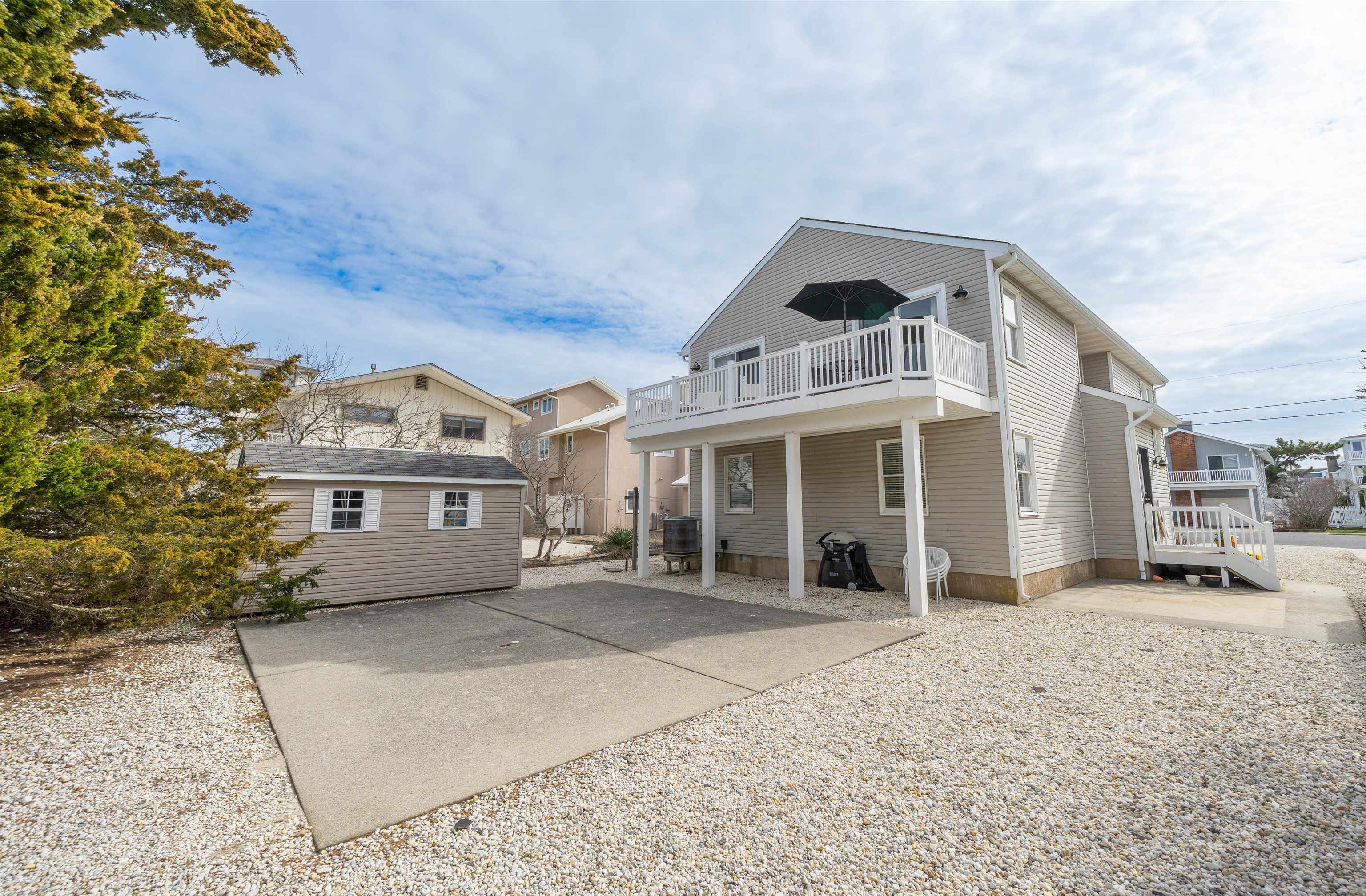 25 9th Street Avalon, NJ 08202 - Photo 23 of 32 a front view of a house with a porch