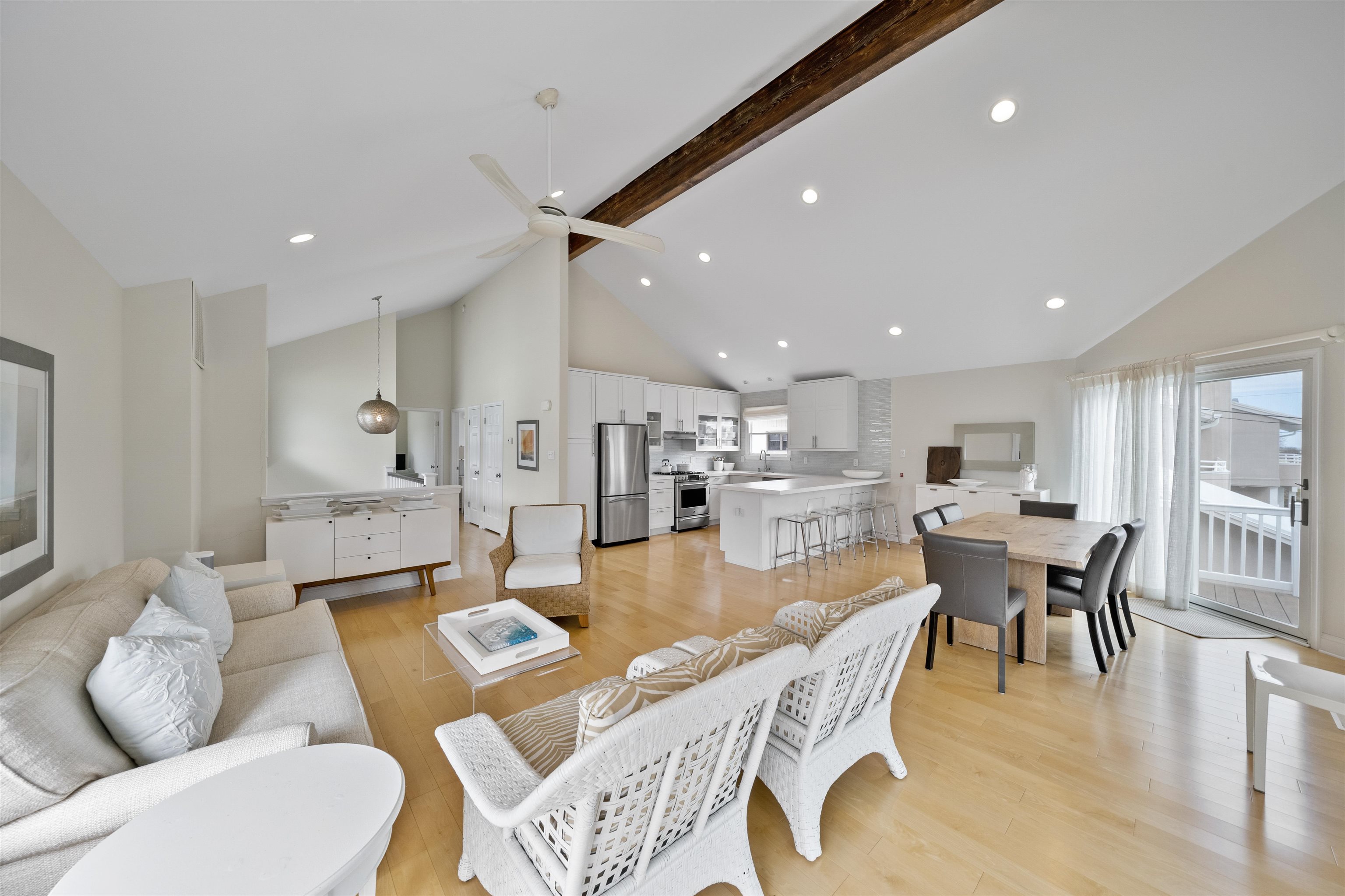 25 9th Street Avalon, NJ 08202 - Photo 5 of 32 a dining room with furniture a wooden floor and kitchen view