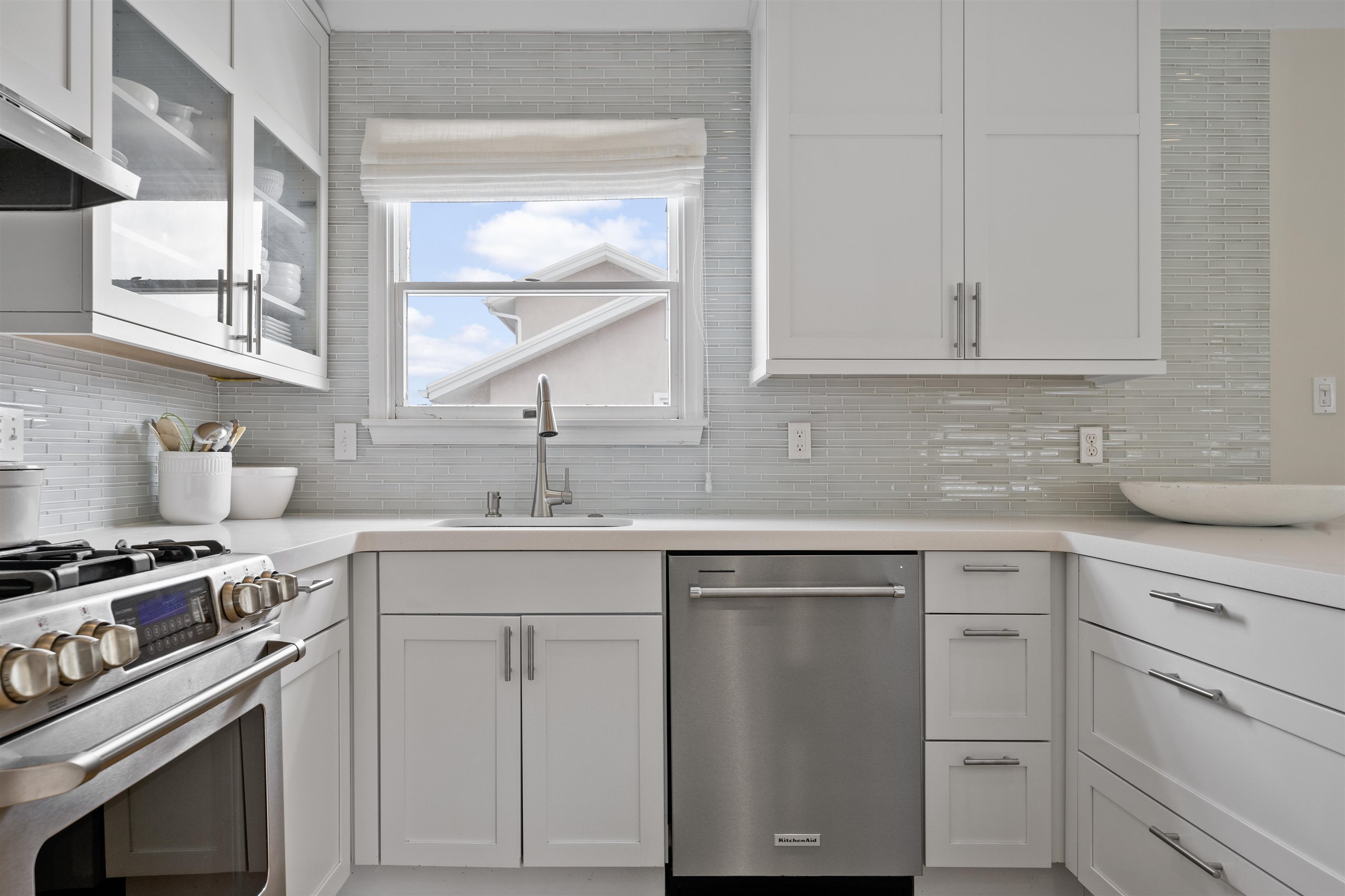 25 9th Street Avalon, NJ 08202 - Photo 8 of 32 a kitchen with cabinets appliances a sink and a window