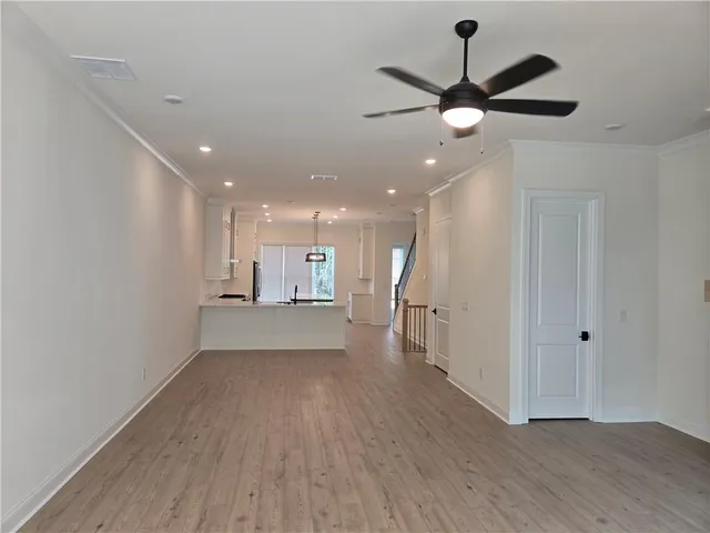 a view of a kitchen with a sink and wooden floor