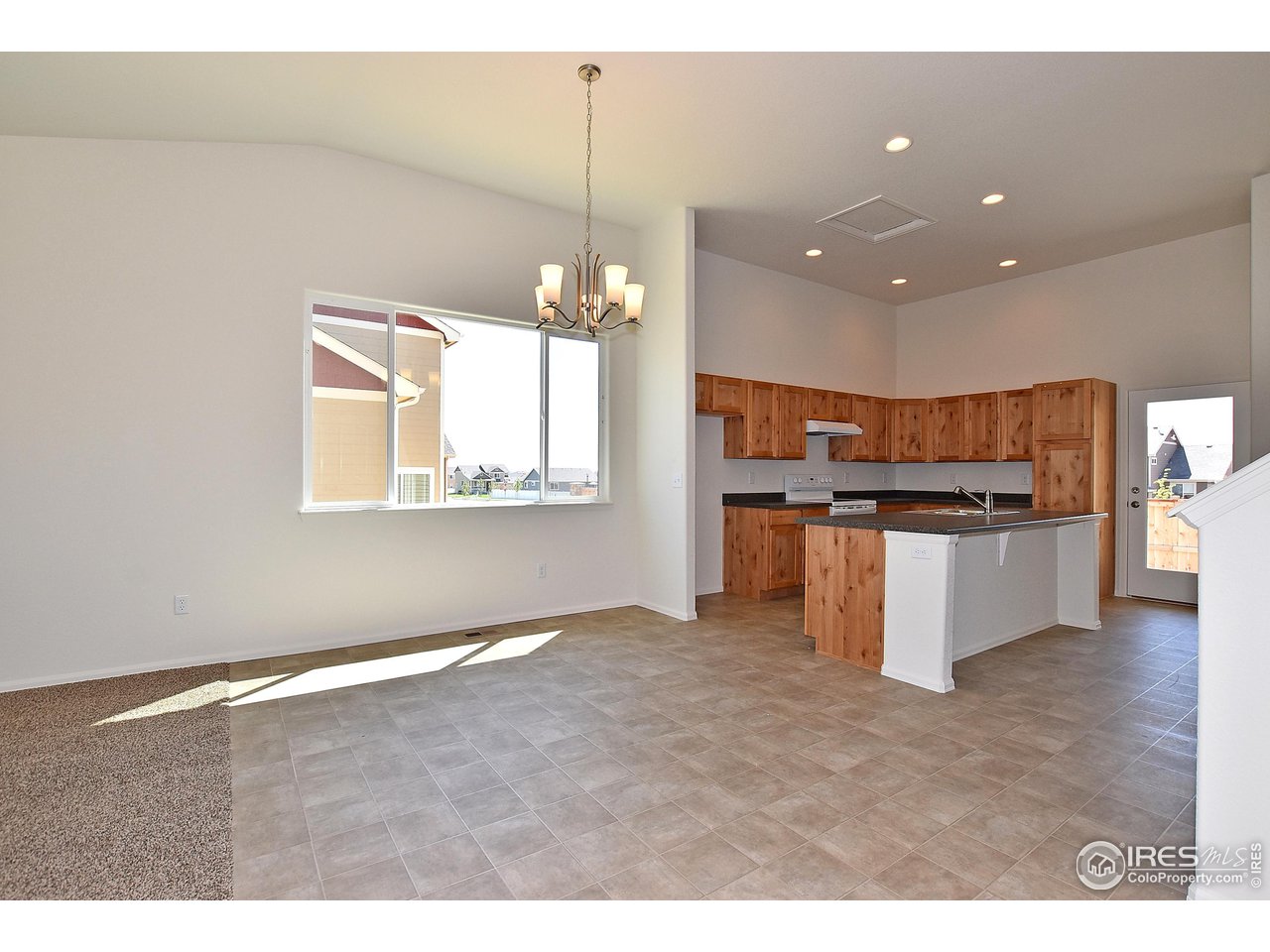 2324 Golden Way Windsor, CO 80550 - Photo 14 of 39 a kitchen with kitchen island stainless steel appliances a refrigerator stove top oven and sink