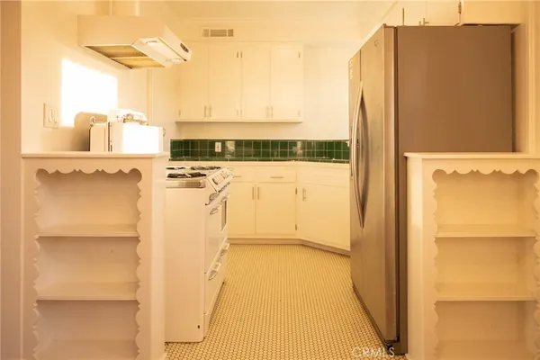 a view of a kitchen with a refrigerator