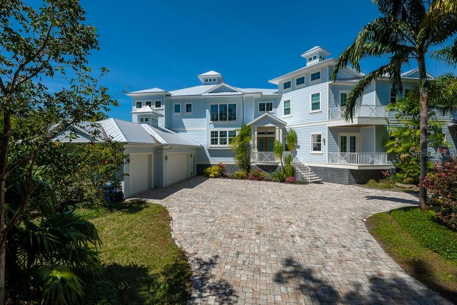 819 Mangrove Point Road Sarasota, FL 34242 - Photo 1 of 1 Front elevation, paver drive, lush landscape, metal roof with coppolas.