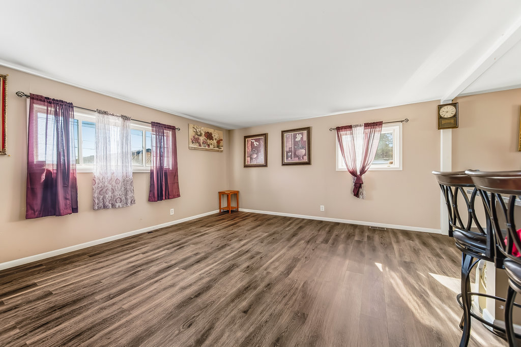 208 South Pinecrest Road Bolingbrook, IL 60440 - Photo 3 of 5 a view of an empty room with wooden floor and a window