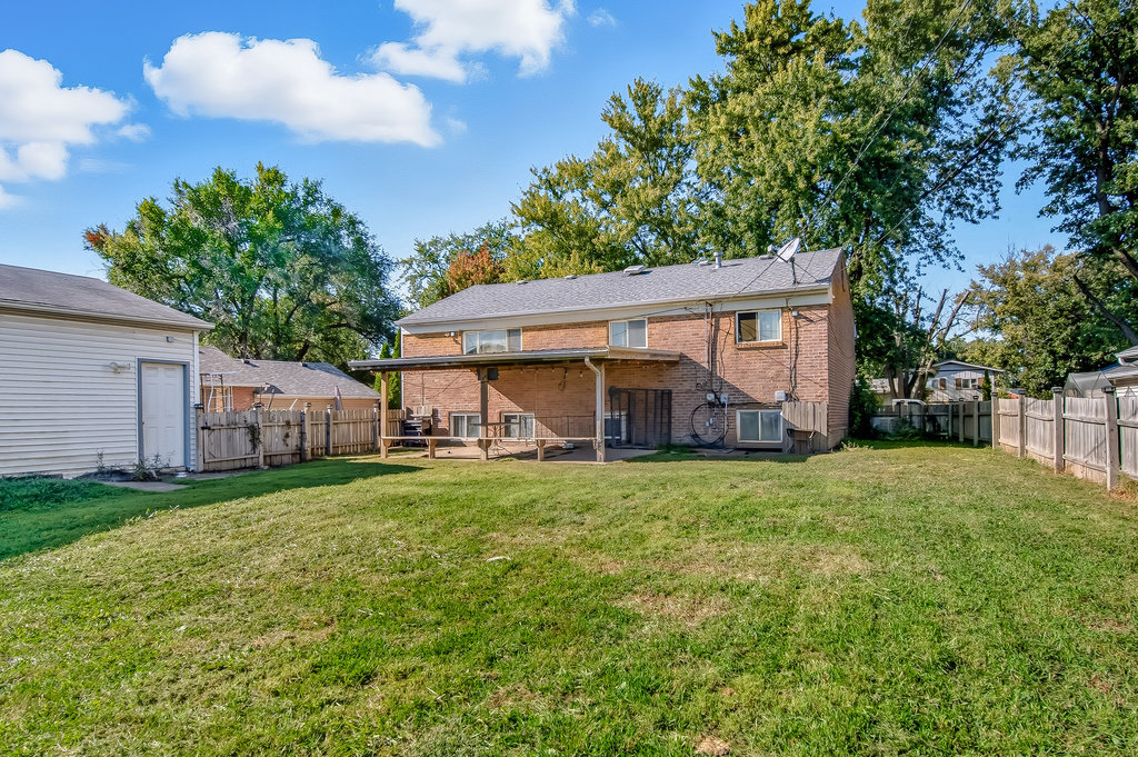 208 South Pinecrest Road Bolingbrook, IL 60440 - Photo 5 of 5 a view of a big house with a big yard and large trees