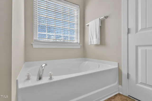 a bedroom with a bed and a ceiling fan