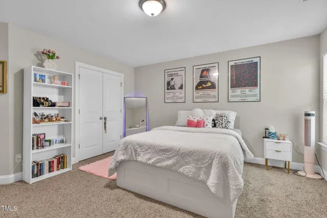 a spacious bedroom with a bed and a window