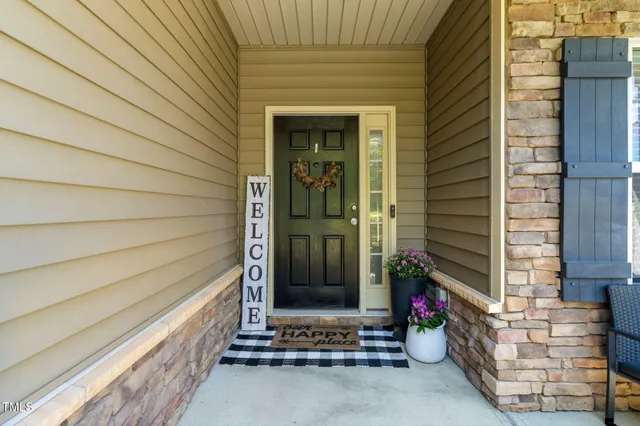a front view of a house with yard and green space