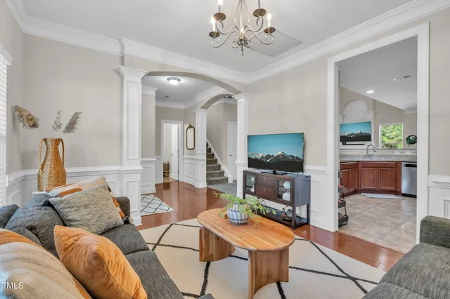 a living room with furniture a dining table and kitchen view