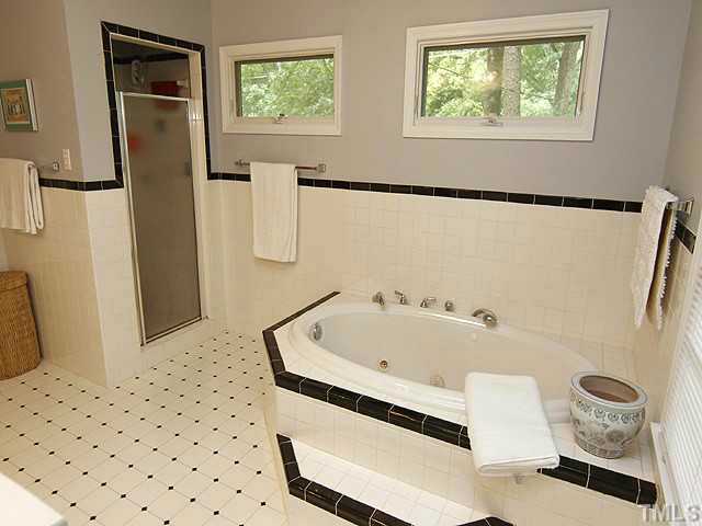 3105 Churchill Road Raleigh, NC 27607 - Photo 13 of 16 a bathroom with a bathtub and a shower