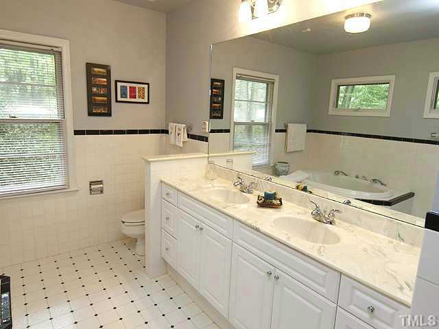 3105 Churchill Road Raleigh, NC 27607 - Photo 14 of 16 a bathroom with a sink a toilet and mirror