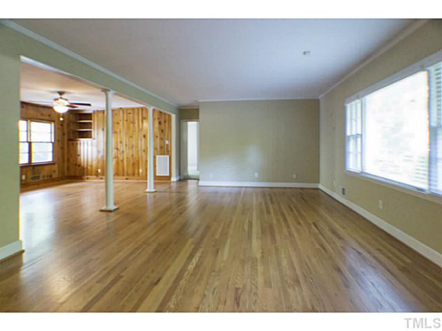 3105 Churchill Road Raleigh, NC 27607 - Photo 8 of 16 a view of an empty room with wooden floor and a window