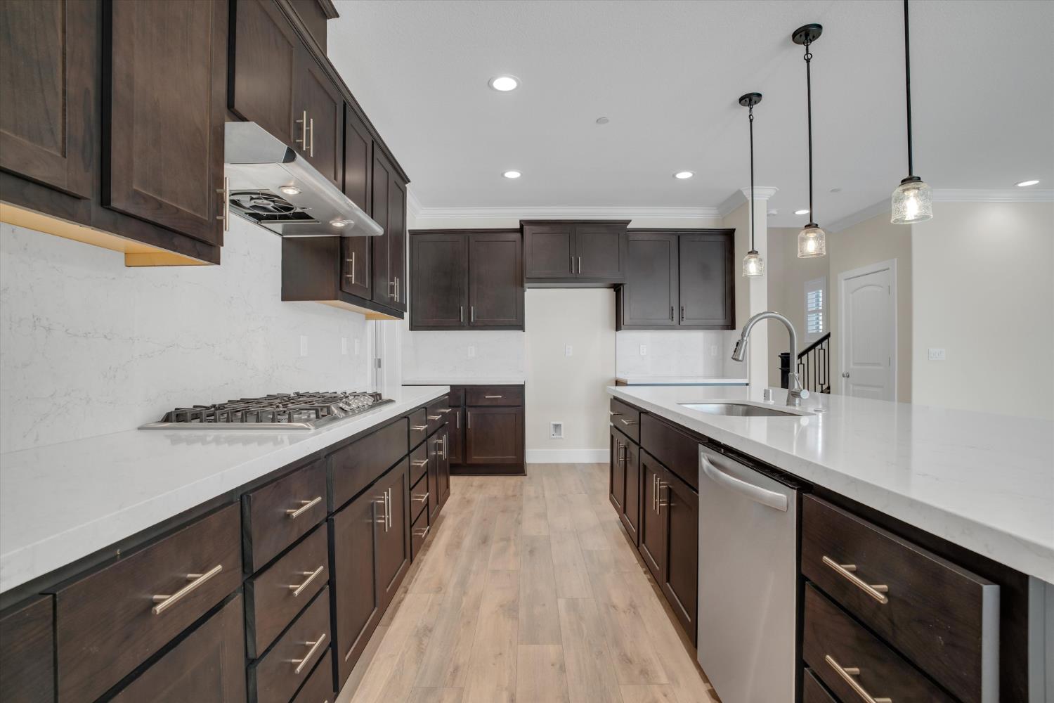 1898 Sanza Road Manteca, CA 95337 - Photo 13 of 41 a large kitchen with stainless steel appliances a sink a stove and a wooden floors